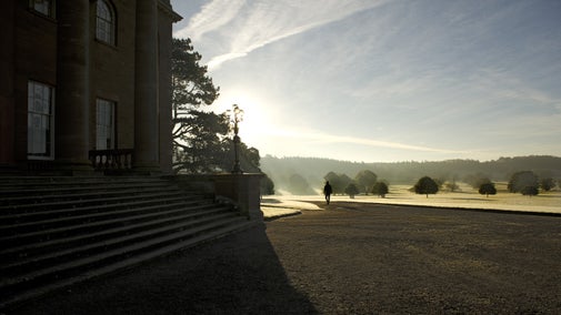 A visitor walking on the drive at Berrington Hall, Herefordshire, on a frosty morning.